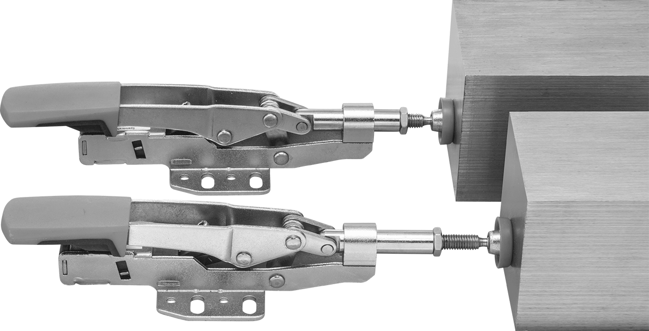 Clamps hold workpieces of different thicknesses without manual adjustment.